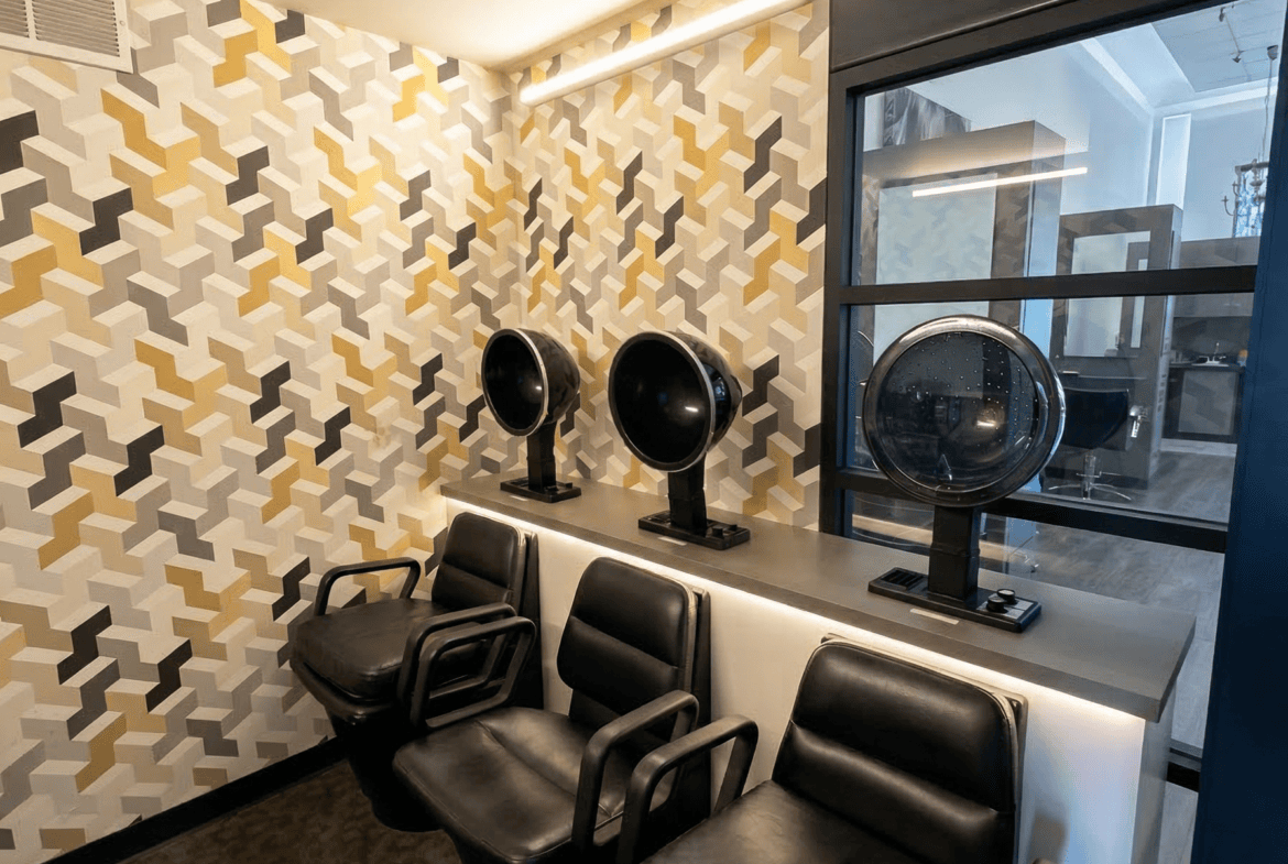 Comfortable salon seating with stylish decor and large window view.