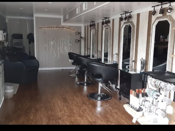 Modern salon interior with styling stations and mirrors for hair services.