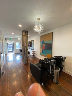 Salon Renter lounge featuring hair styling chairs, contemporary artwork, and inviting interior desig.