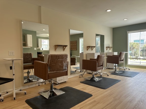 Hair salon styling stations with chairs and mirrors for rent.