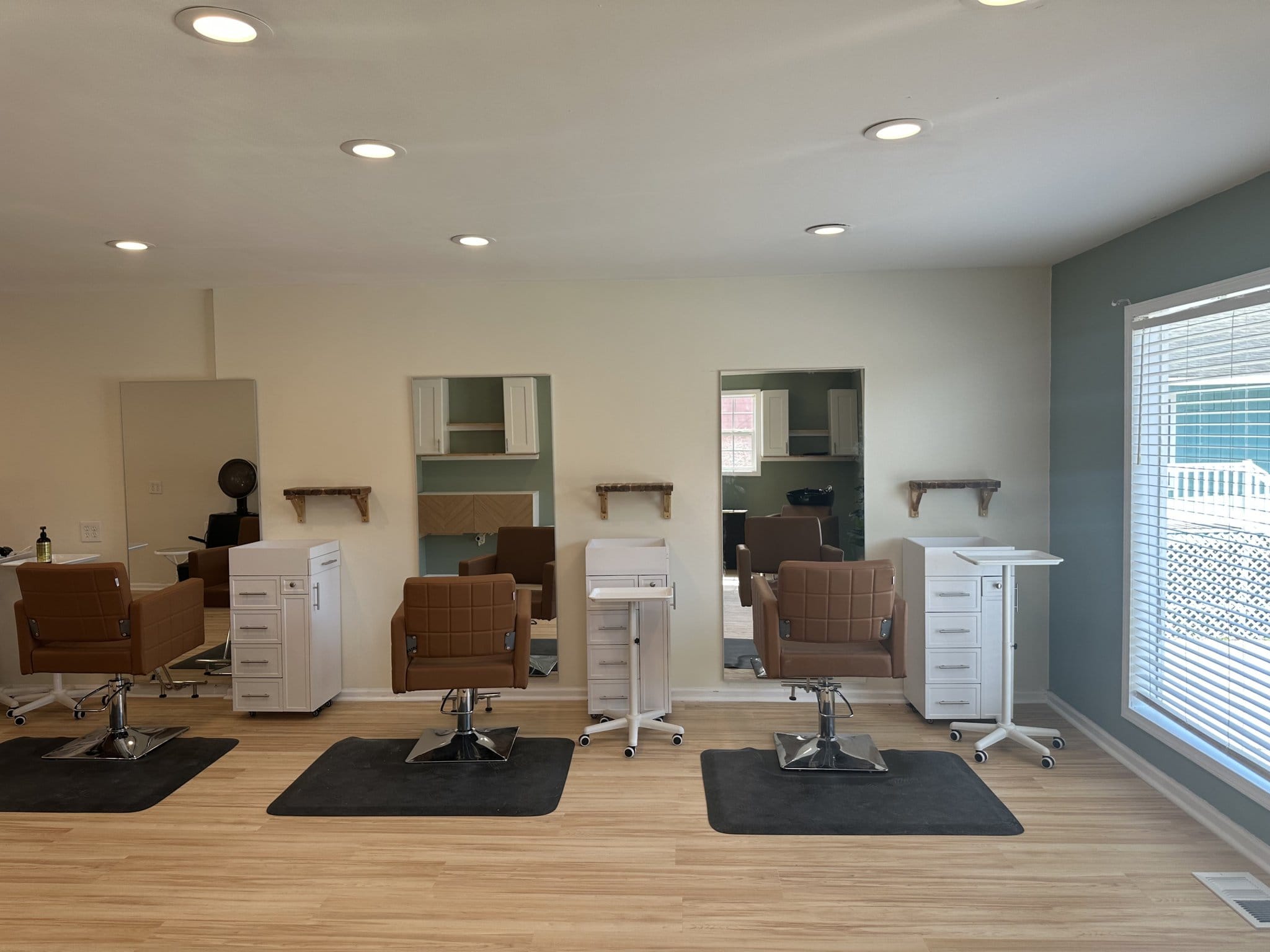 Modern salon styling stations with mirrors, chairs, and storage in a bright, welcoming space. Perfec.