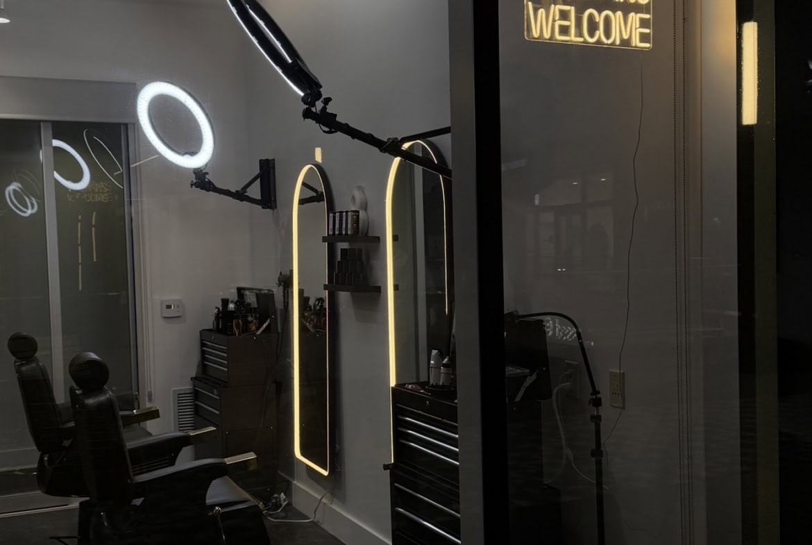 Modern salon interior with walk-in welcome sign and styling stations.