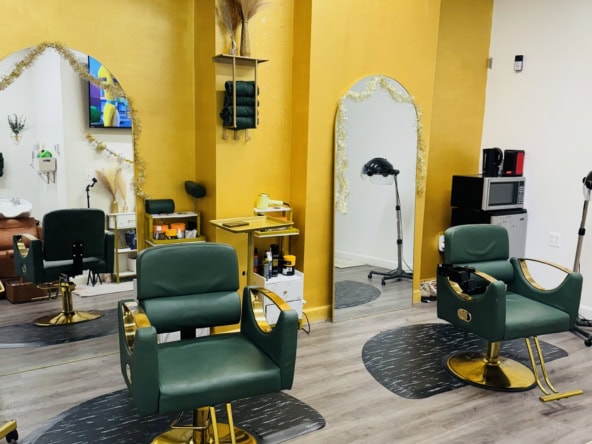 Stylish salon with green chairs, mirrors, and professional hair styling stations.