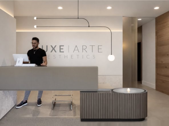 Modern salon reception with minimalistic design and stylish lighting.