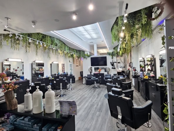 Salon Renter interior with styling chairs, mirrors, and lush hanging plants for a relaxing beauty ex.