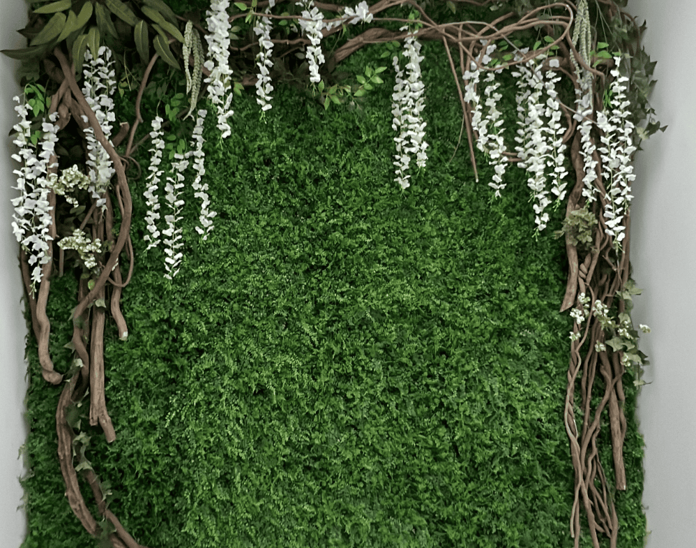 Green wall with floral and vine decor for salon interior design.