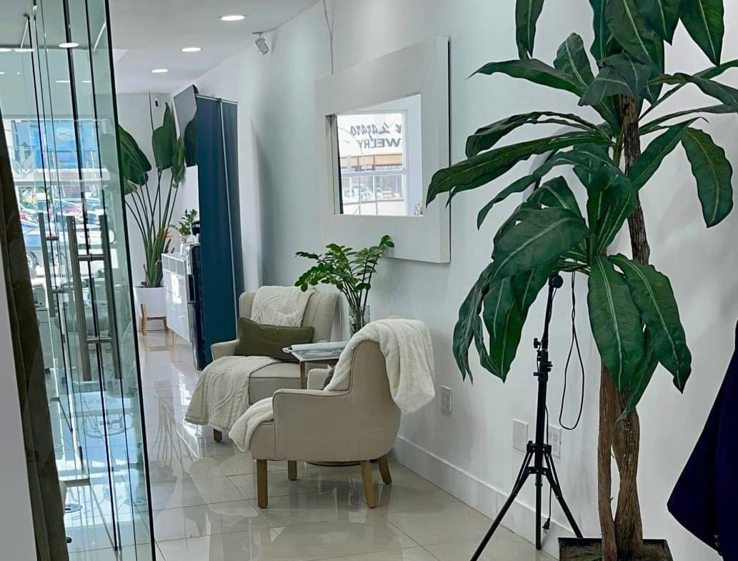 Salon Renter interior with cozy seating and greenery for a welcoming atmosphere.