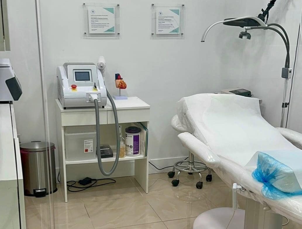 Medical spa treatment room with advanced equipment and a comfortable treatment bed.