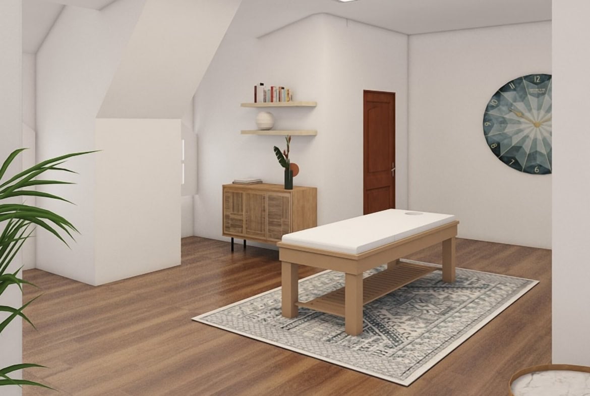 Bright salon treatment room with comfortable massage table and stylish decor.