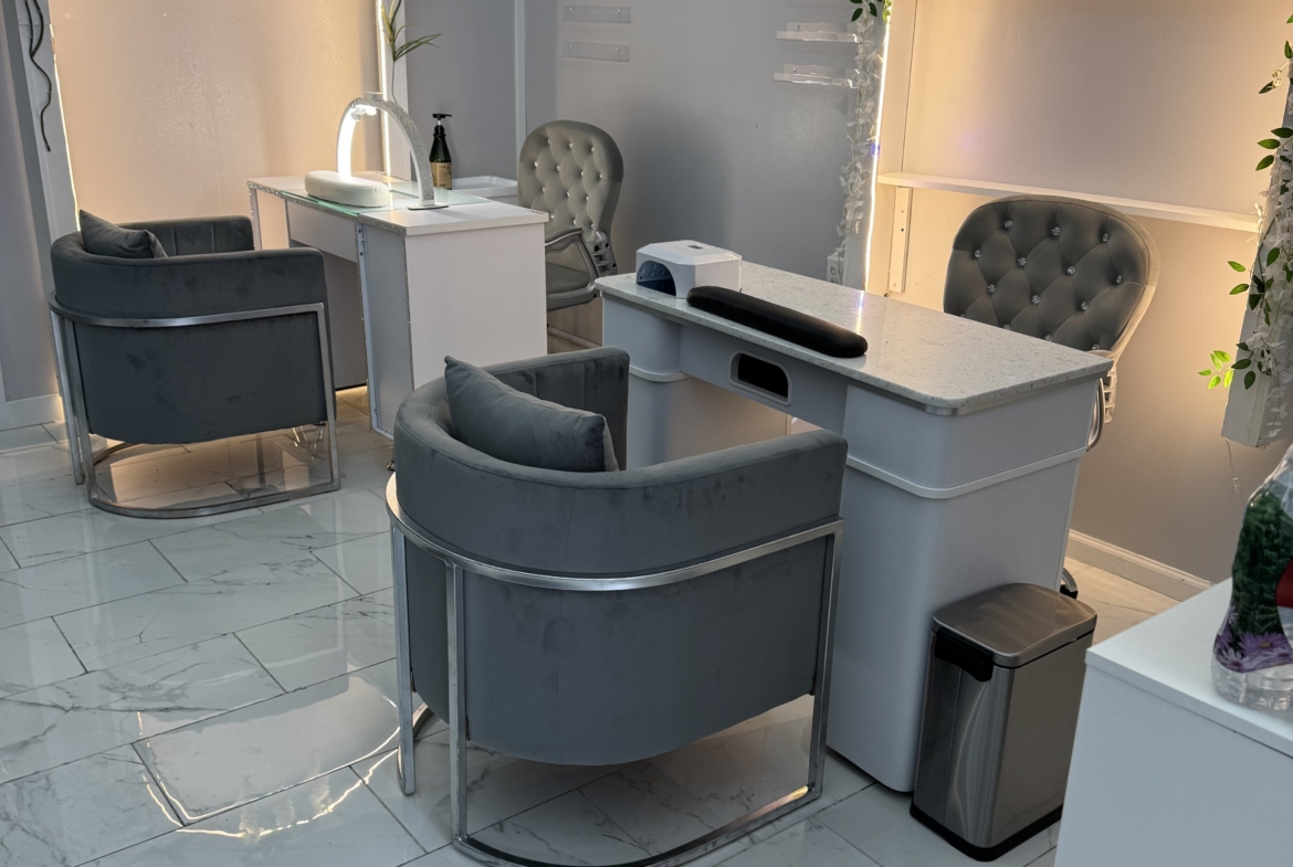 Modern salon station with comfortable chairs and stylish decor for hair styling.