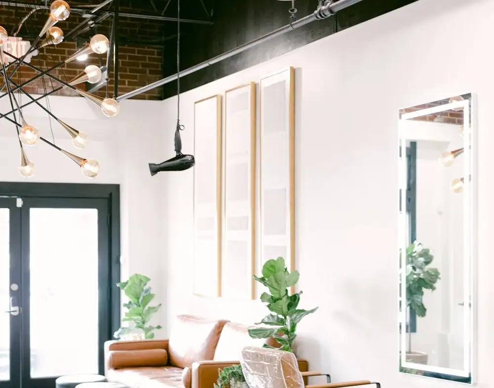 Elegant salon space featuring comfortable chairs and contemporary design for independent stylists.