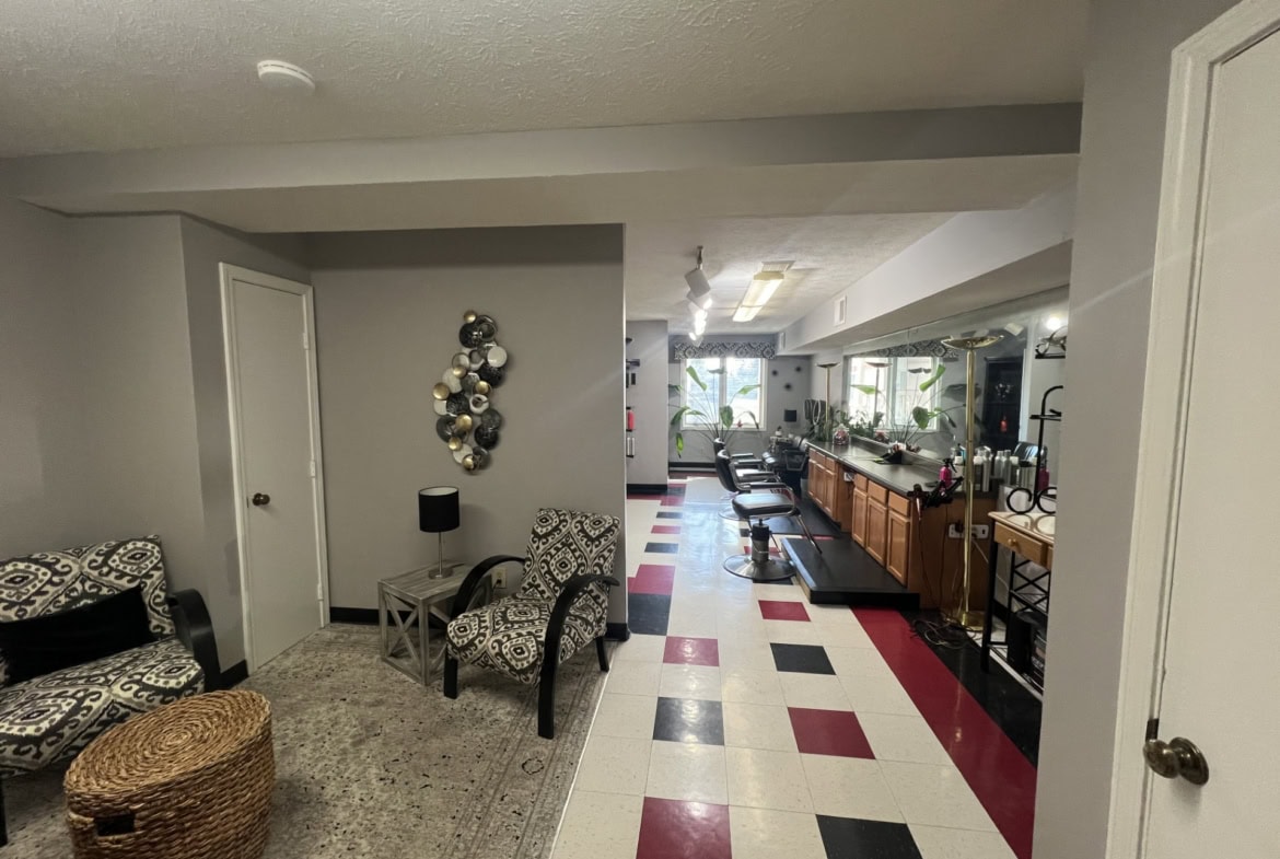 Modern salon lounge with seating and decor, ideal for clients and staff.