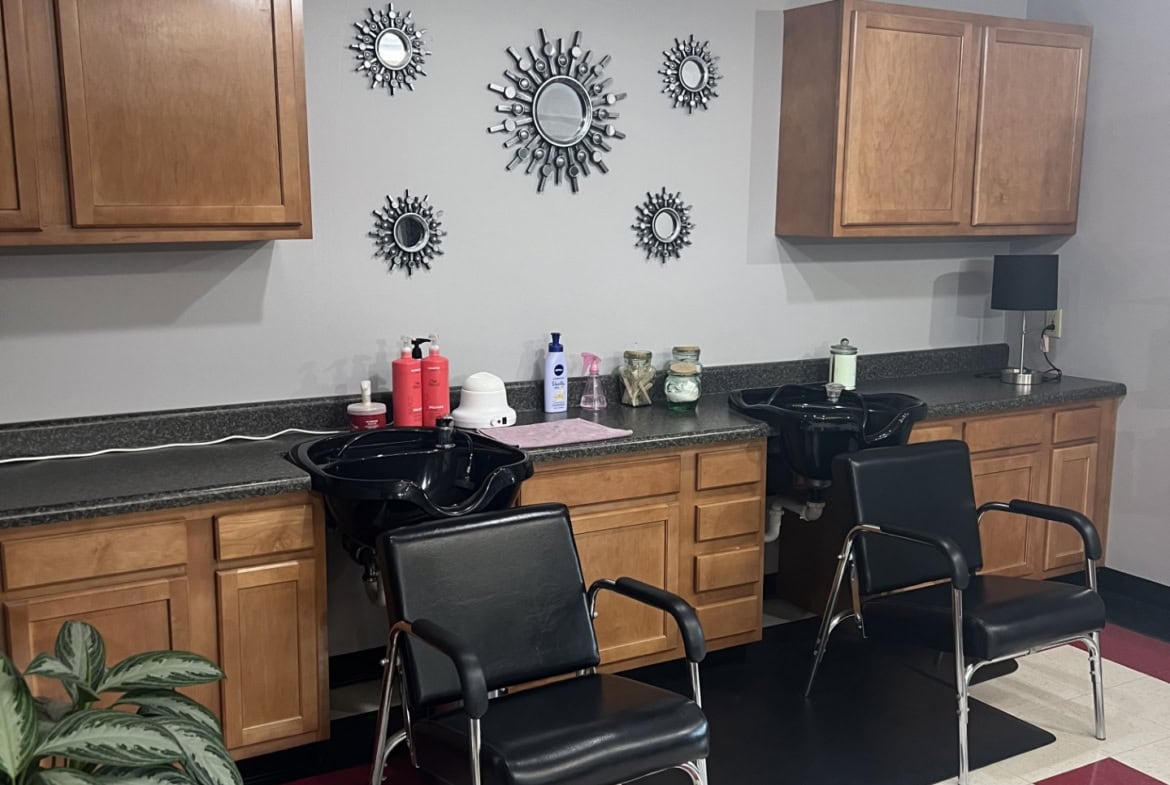 Salon Renter hair station with mirrors, chairs, and styling tools in a modern salon setting.
