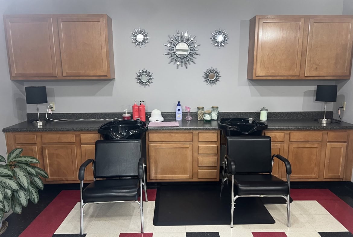 Hair Salon Renter Station with two black chairs and wooden cabinets.