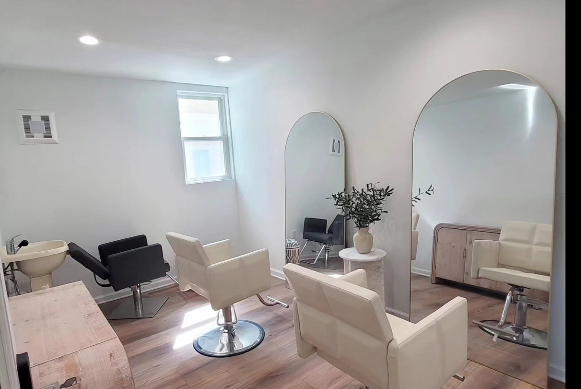 Modern salon interior with styling chairs, large mirrors, and natural light, ideal for hair and beau.