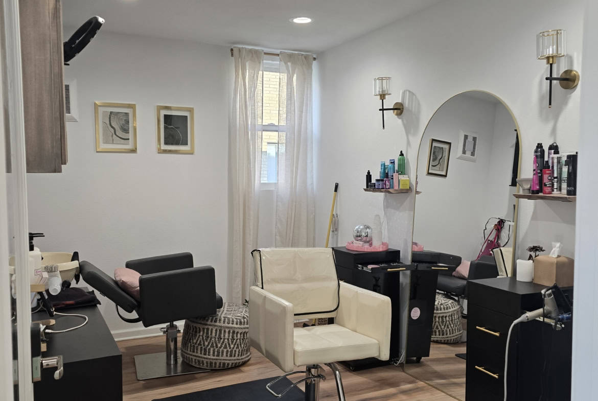 Interior view of a modern salon with styling chairs and hair products.