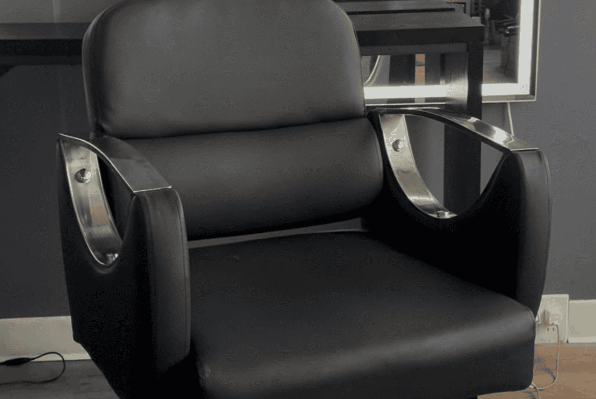 Stylish black salon chair with comfortable padding and durable design.