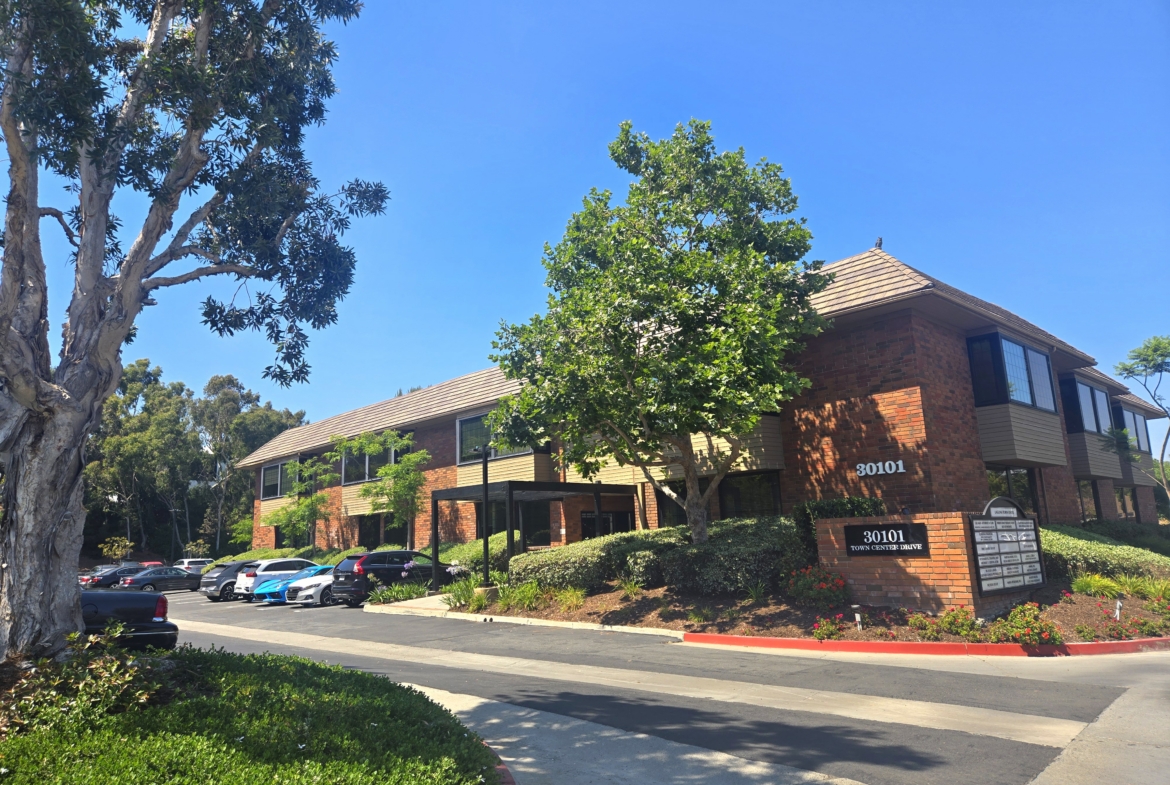 Office building for salon renters with parking and landscaping.