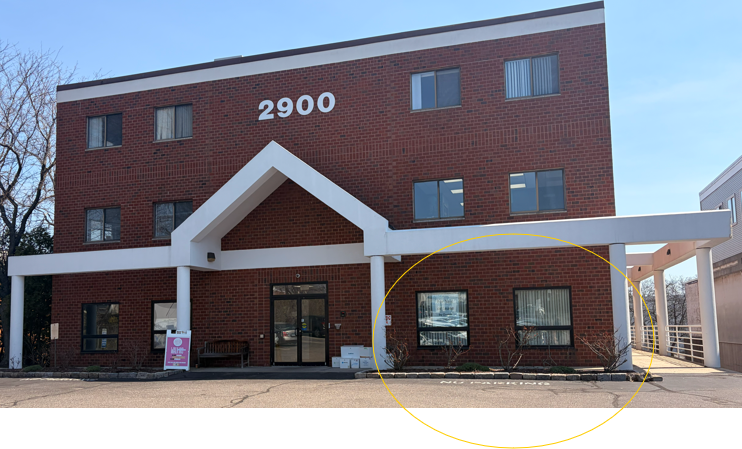 Commercial building for salon rentals at 2900 address with parking.