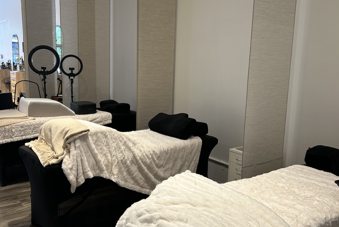 Spa treatment room with massage beds and relaxing ambiance.