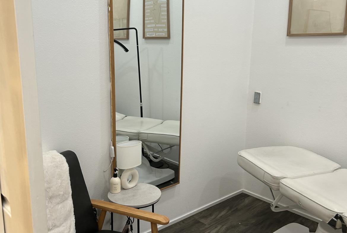 Salon Renter treatment room featuring a chair, mirror, and minimal decor for professional beauty ser.