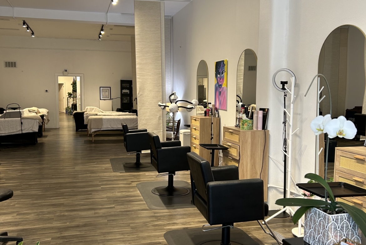 Modern salon interior with styling stations and mirrors for hair services.