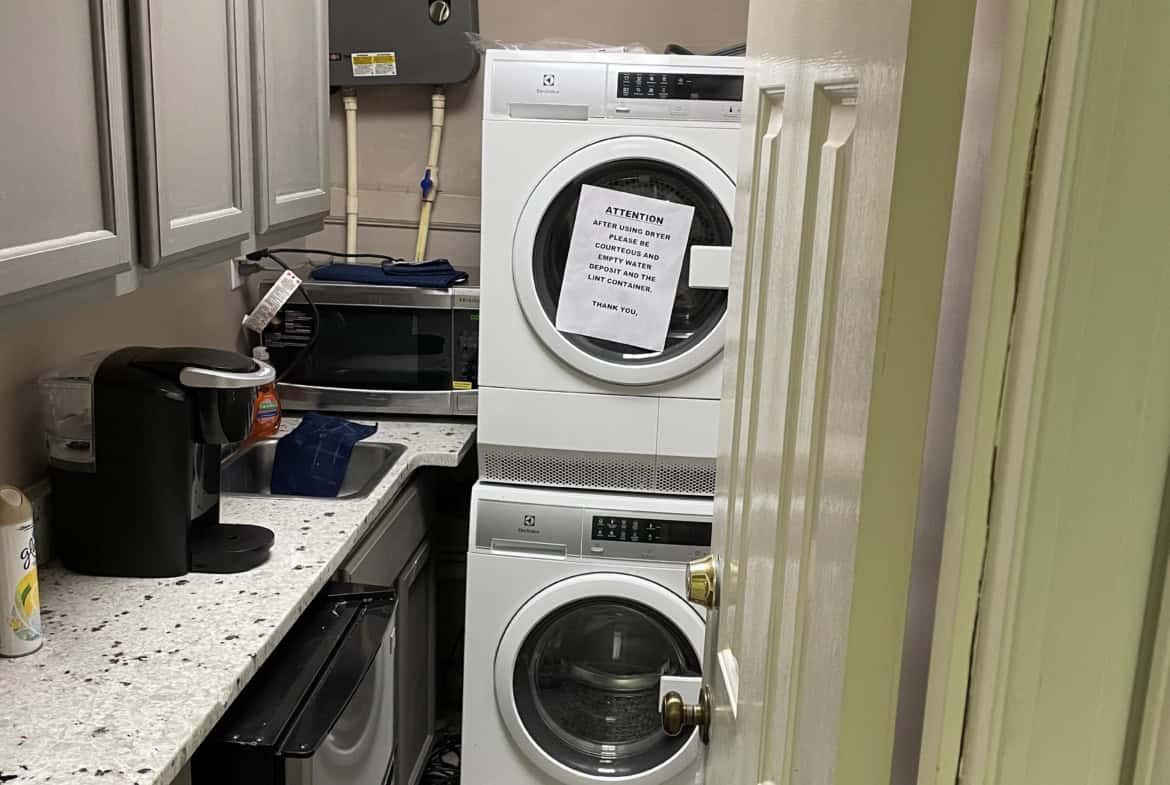 Laundry room with stacked washer and dryer in a small utility space.