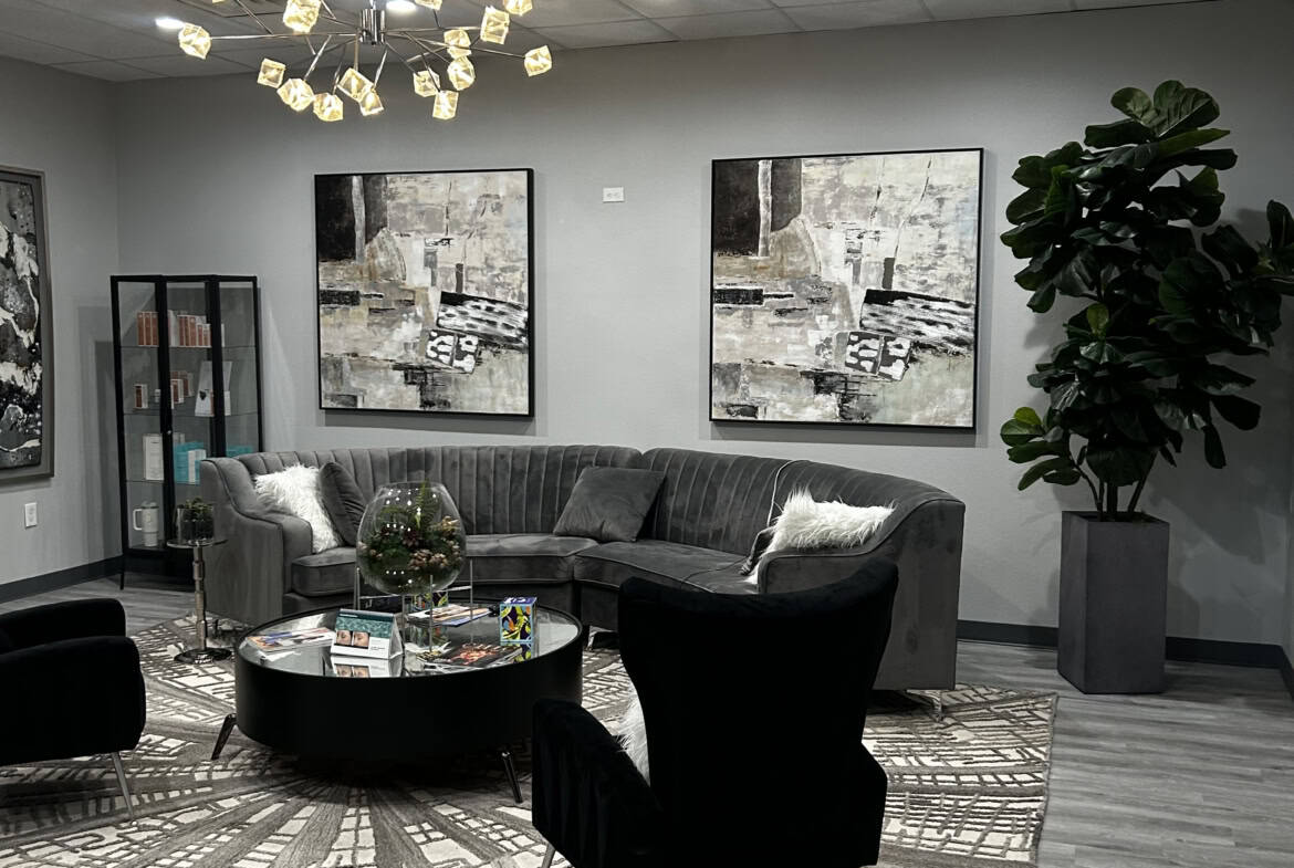 Comfortable salon lounge featuring modern furniture, elegant artwork, and ambient lighting for a rel.