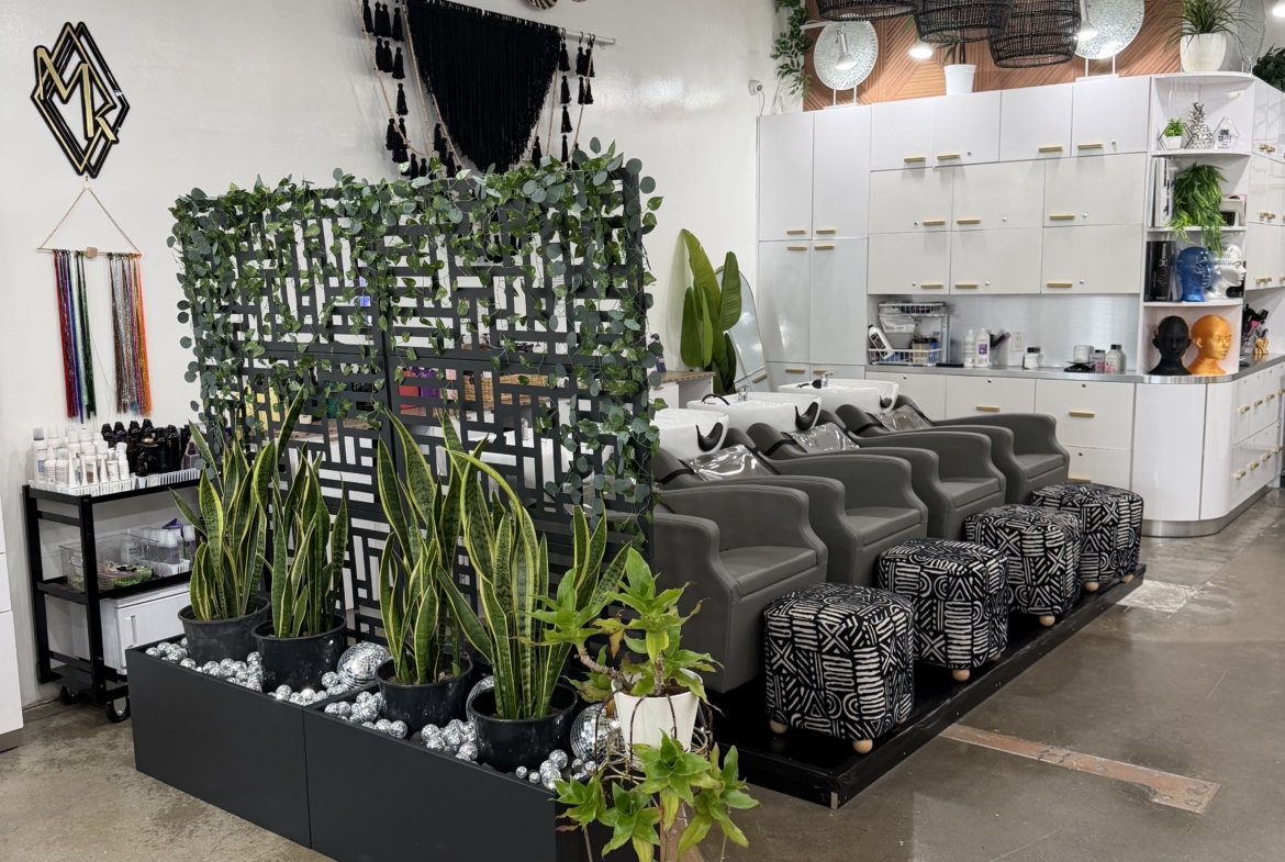 Stylish salon waiting area with modern decor, plants, and comfortable chairs for clients.