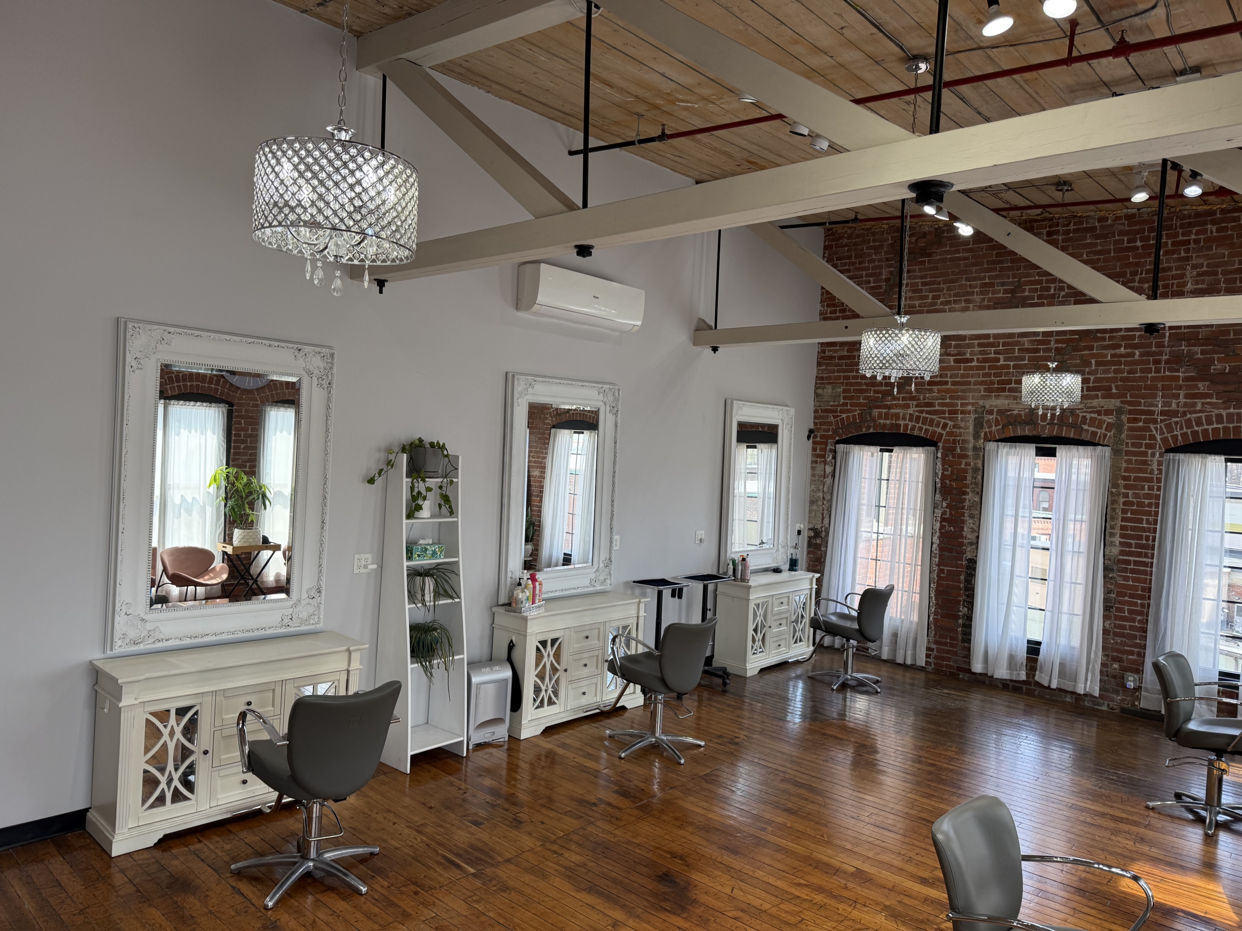 Modern salon interior with styling stations, large windows, and elegant lighting for a professional.