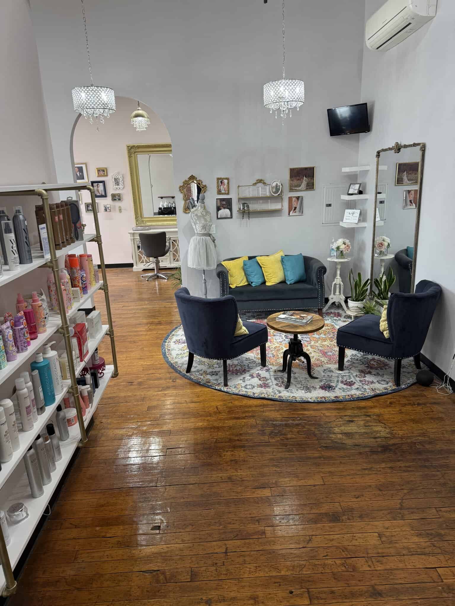 Cozy salon lounge with stylish decor, comfortable seating, and vibrant accents for clients.