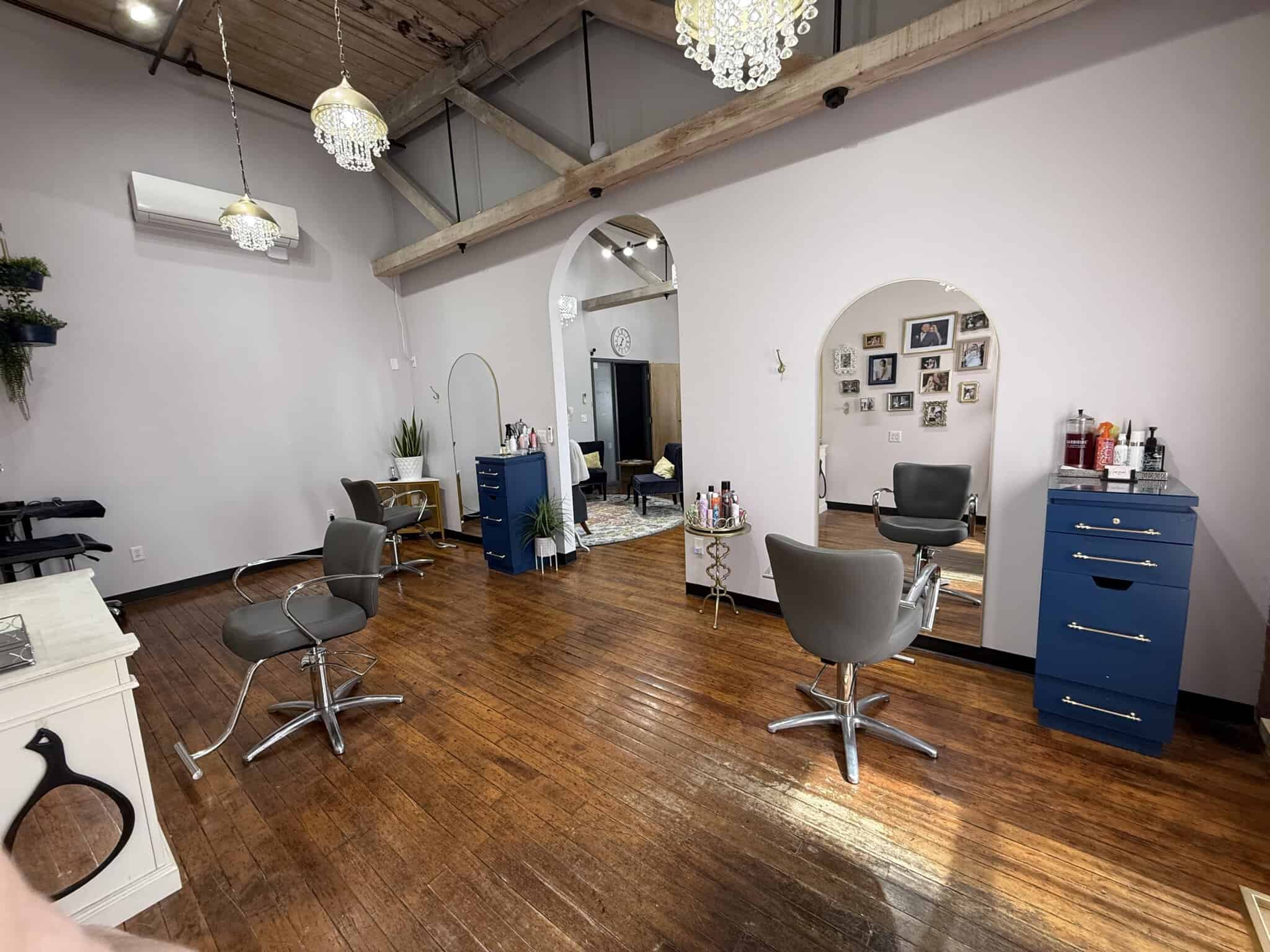 Stylish salon with multiple styling chairs, mirrors, and decor for hair and beauty services.