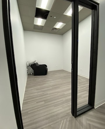 Interior view of a premium salon suite with a hair washing station, perfect for beauty professionals.