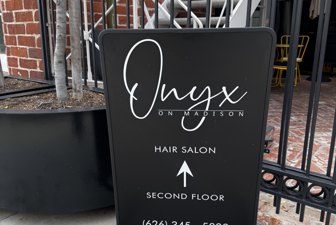 Onyx Hair Salon sign with directional arrow to second floor, located in Madison.