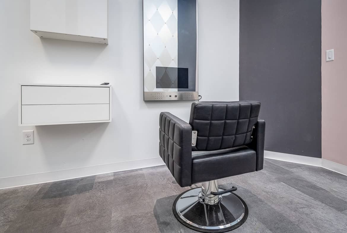 Modern salon styling chair in a sleek, minimalist salon interior.