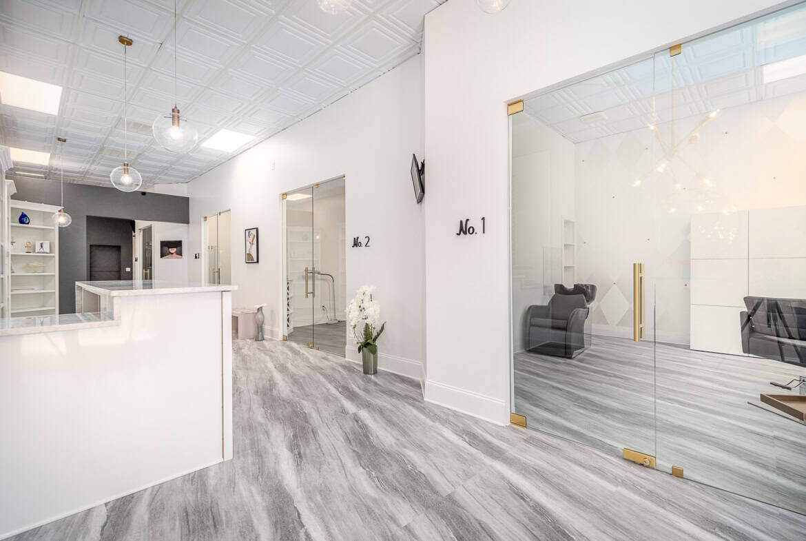 Contemporary salon rental with private rooms, lounge area, and stylish decor.