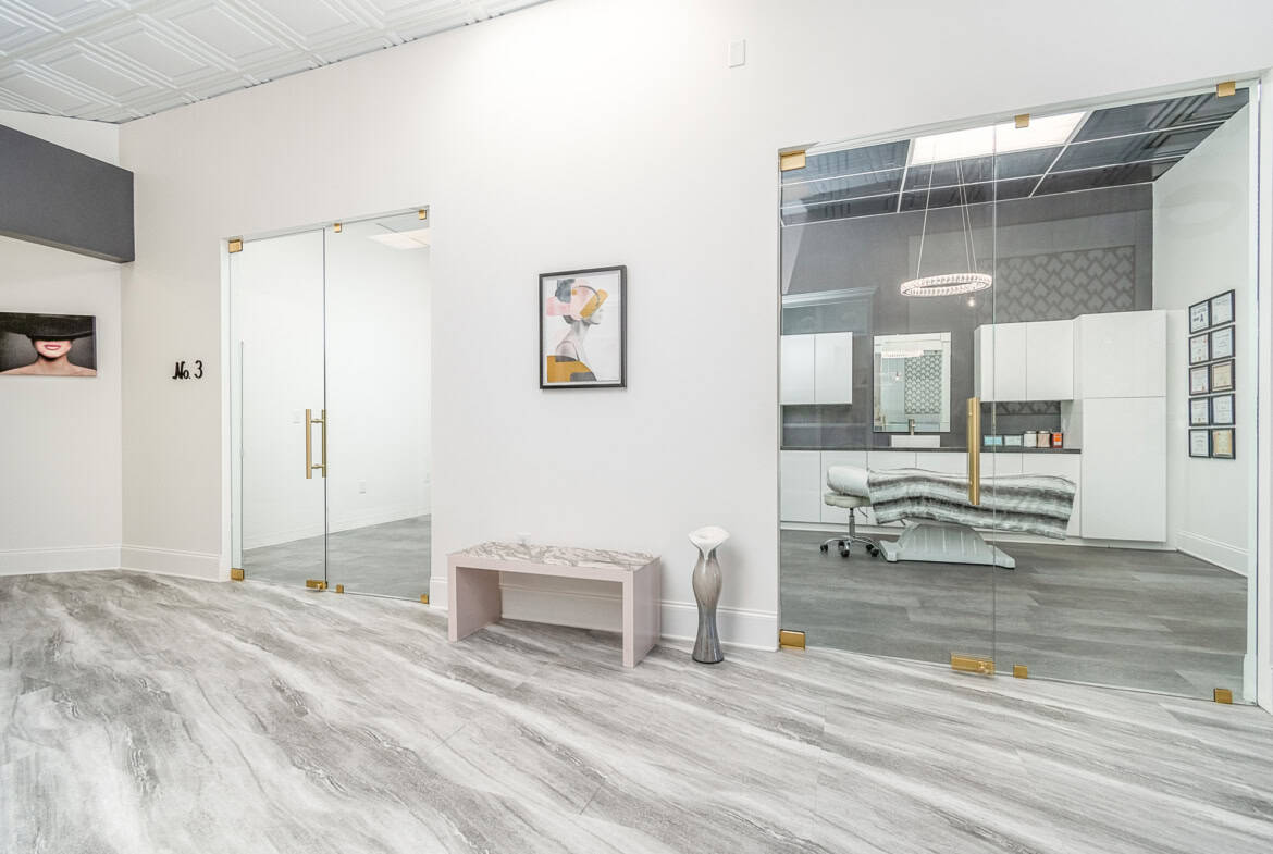 Modern salon interior with glass doors and stylish decor.