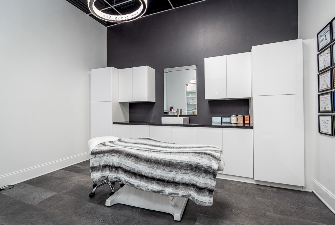 Modern salon station with white cabinets and styling chair for rent.