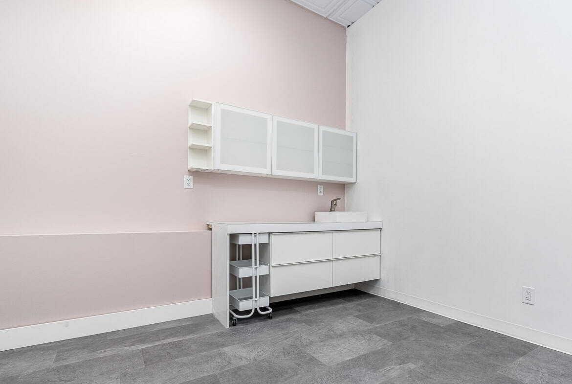 Salon Renter workspace with storage cabinets and counter for beauty professionals.