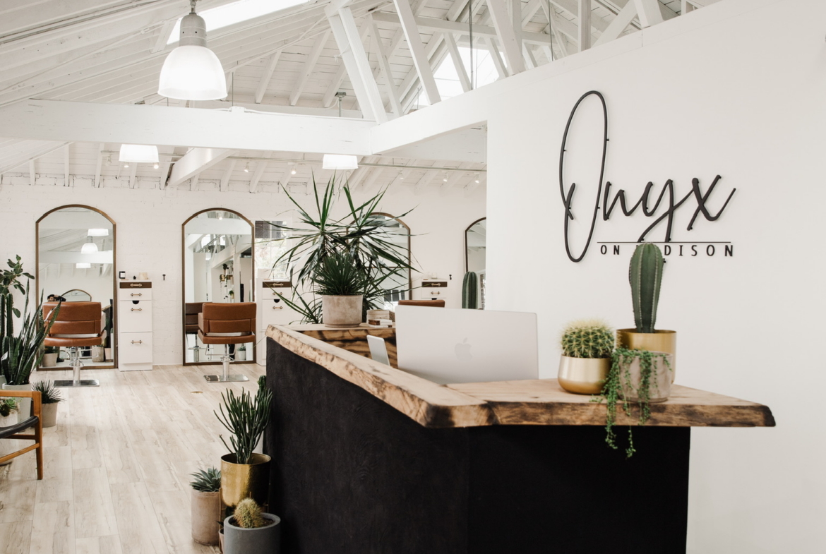 Modern salon reception with stylish decor, natural light, and a welcoming atmosphere for clients.