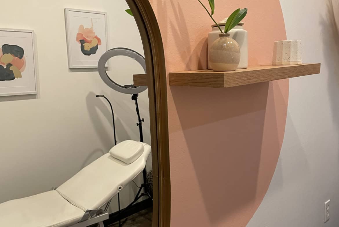 Relaxing salon treatment room with comfortable chair and stylish decor.