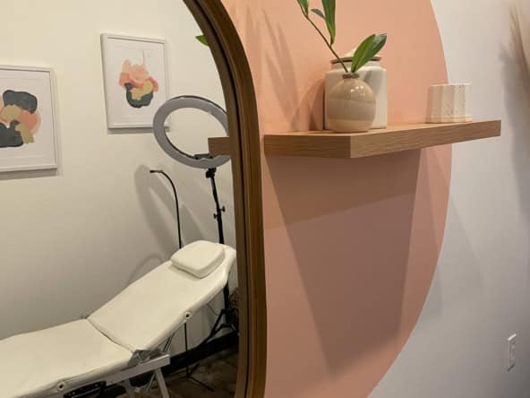 Relaxing salon treatment room with comfortable chair and stylish decor.