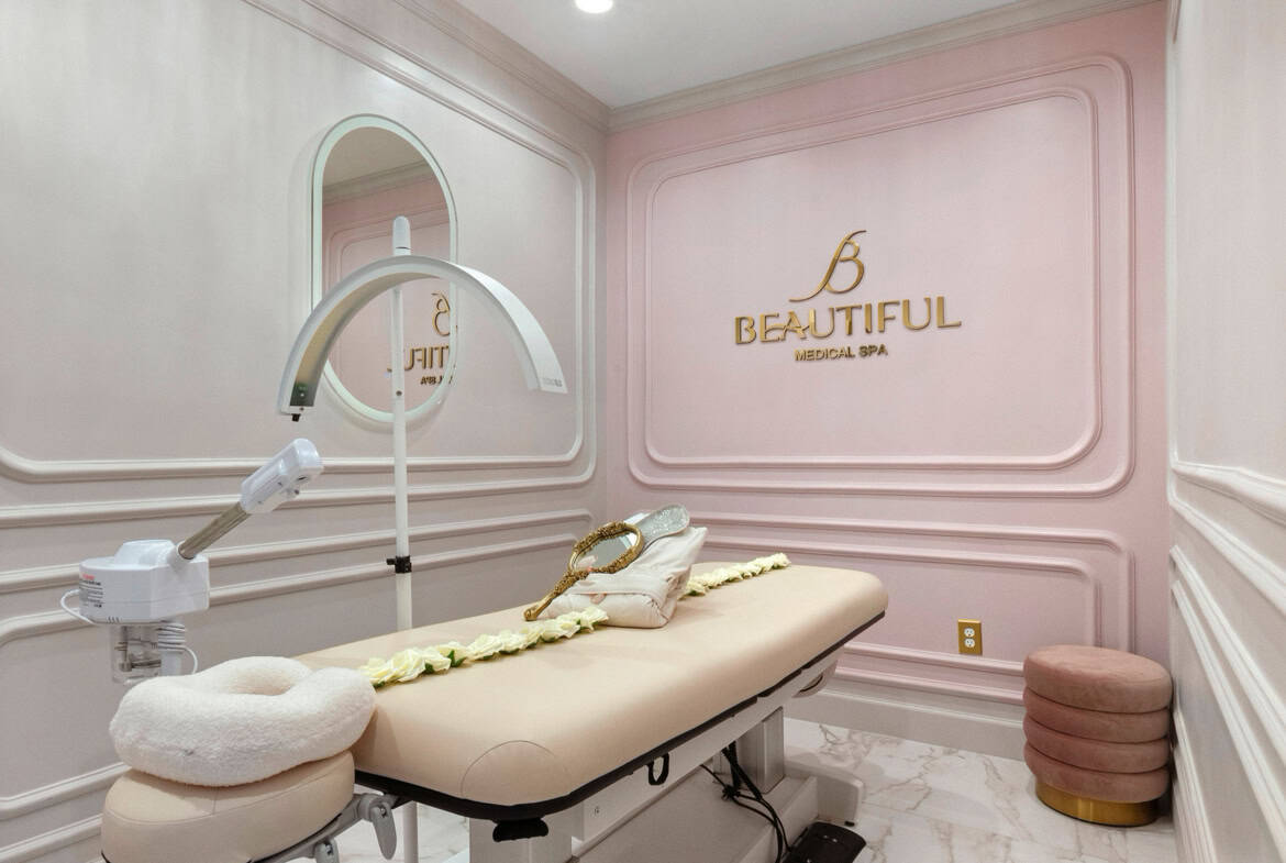 Modern salon treatment room with luxurious decor and comfortable massage bed.