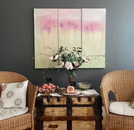 Beautiful floral arrangement and artwork display in a stylish salon setting.