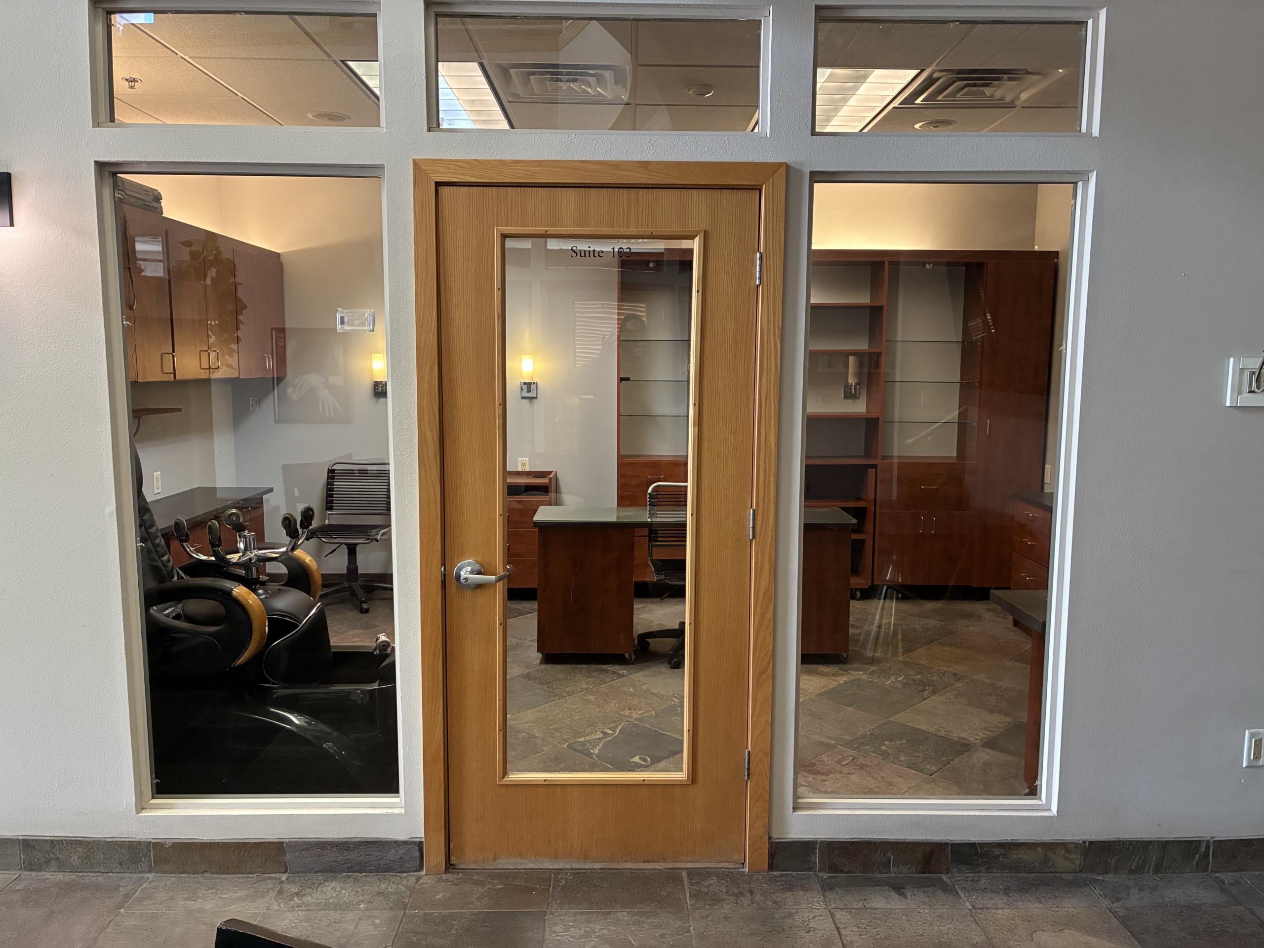 Salon rental office with glass door and interior workspace for beauty professionals.