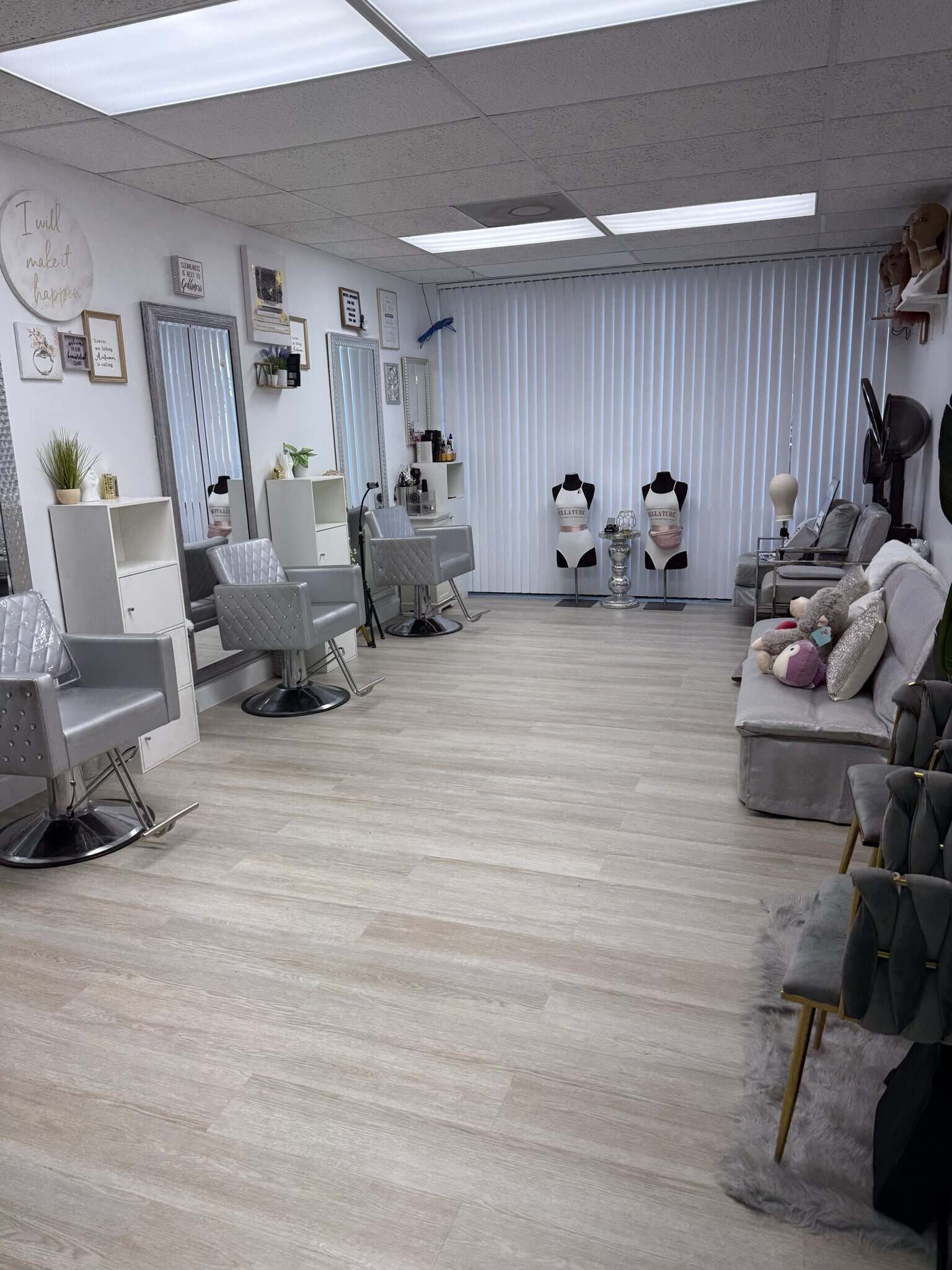 Salon Renter hair styling station featuring mannequin heads, styling chairs, and cozy seating area i.