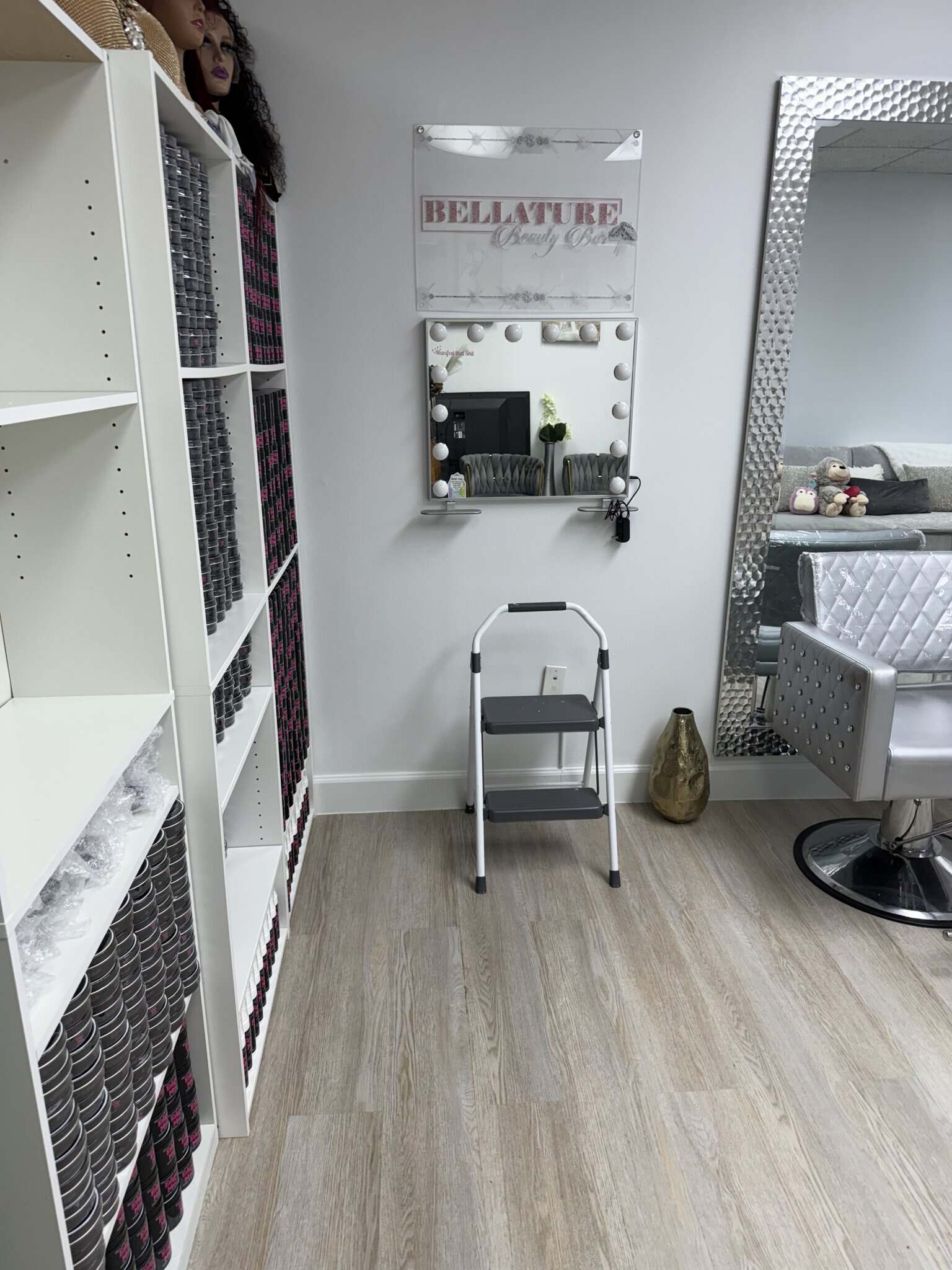 Modern salon interior with styling station, mirror, and salon chair for hair and beauty services.
