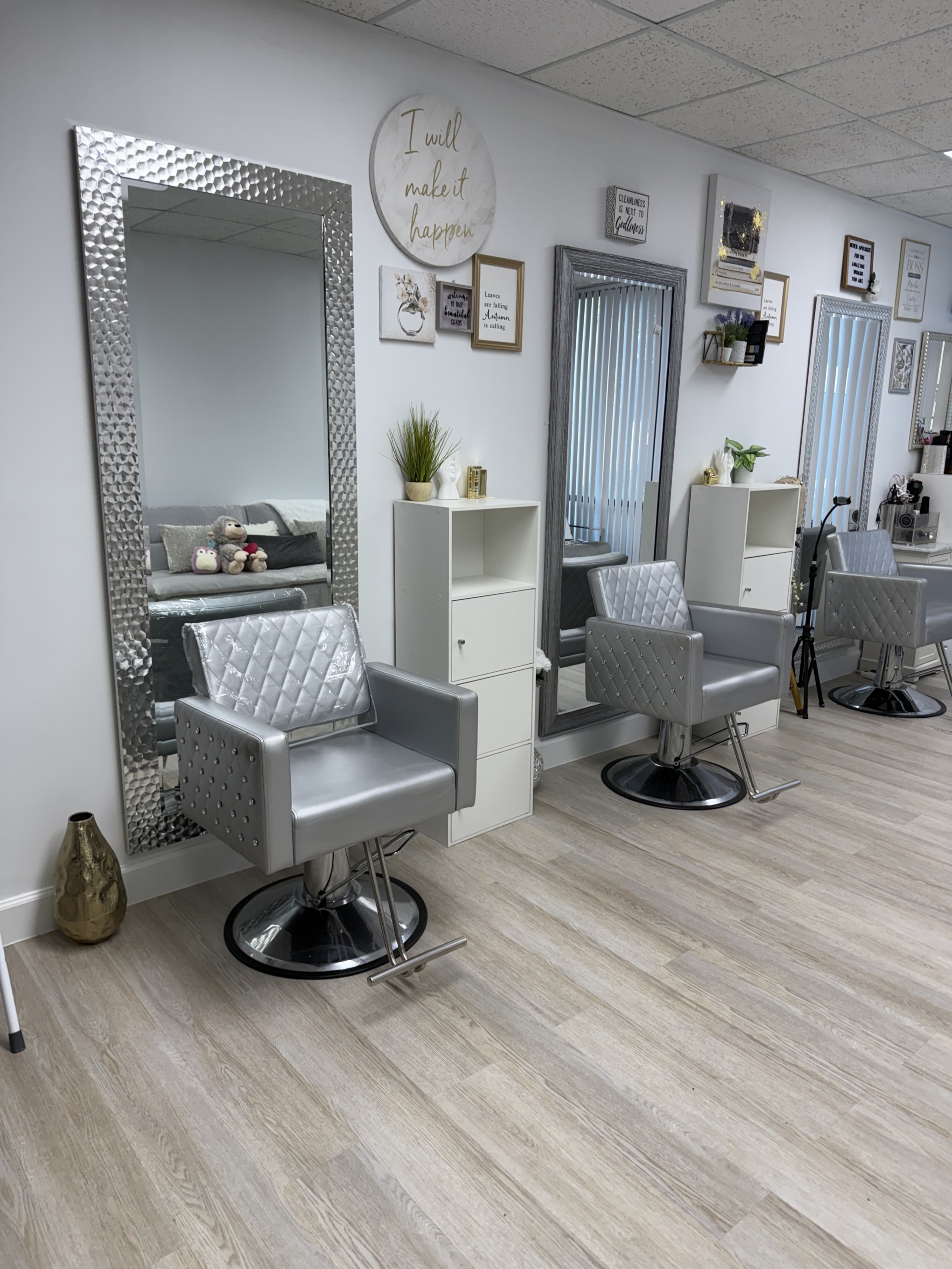 Modern salon styling chairs with large mirrors and decor for a professional hair salon environment.