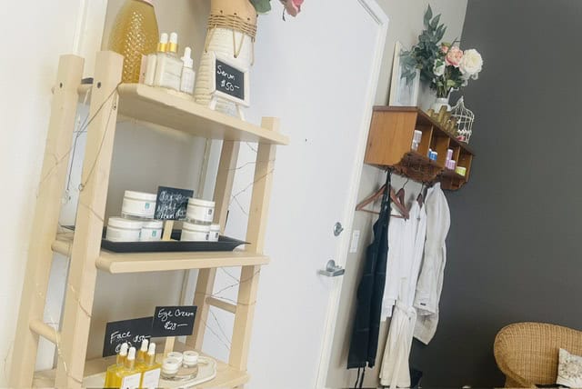 Beauty products and cozy salon interior with shelves and decor.
