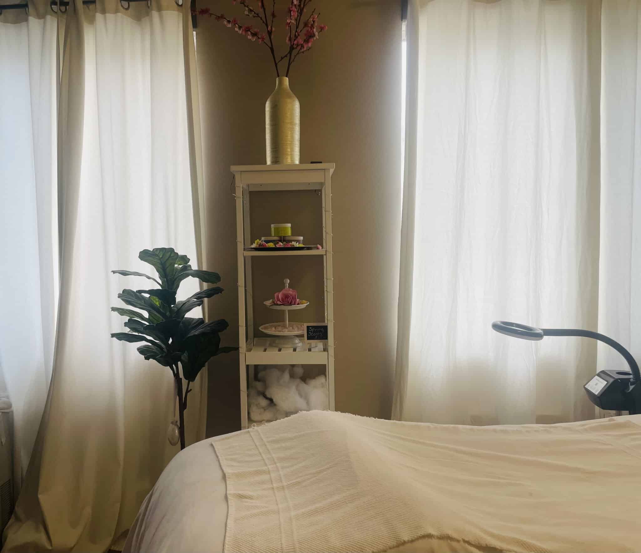 Spa room with cozy bed, elegant decor, and calming ambiance for salon or wellness services.